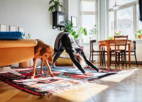 woman doing yoga stretches with her dog