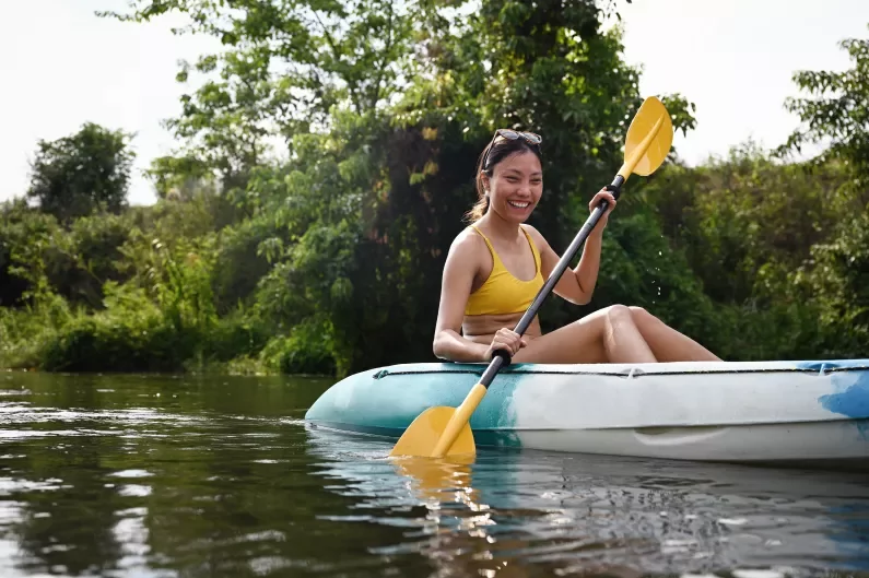 a woman kayaking in a river