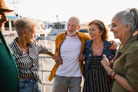 a group of old people near a boat dock