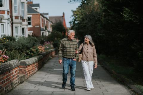 an old couple out on a walk in a residential neighbourhood