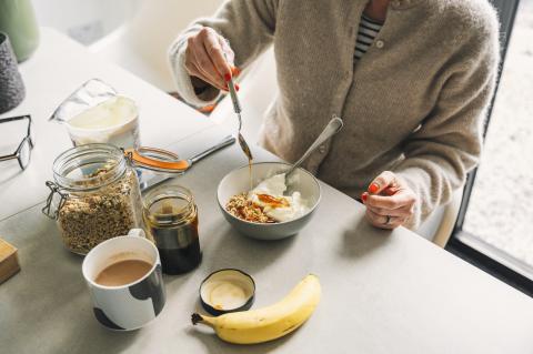 person sitting at a table with a breakfast spread in front of them